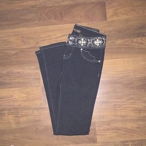 Black jeans with yellow cross